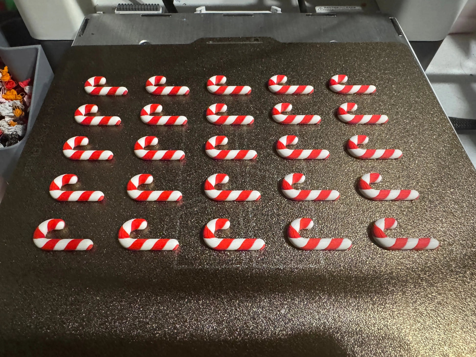 Row of candy cane-shaped cookies on a baking tray