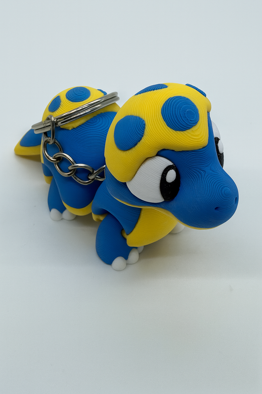 Flexible Baby Dinosaur Keychain: Articulated Blue & Yellow Dino Fidget Toy for Dinosaur Lovers