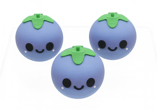 Three blueberry-shaped toys with smiling faces on a white background