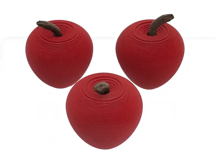 Three red apples with brown stems on a white background