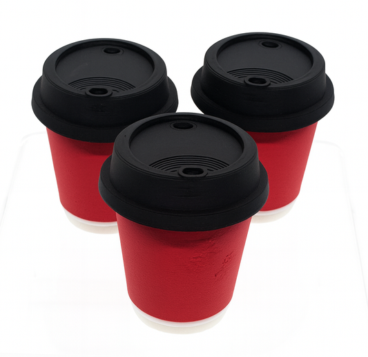 Three red cups with black lids on a white background