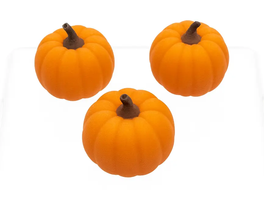 Three small orange pumpkins with brown stems on a white background