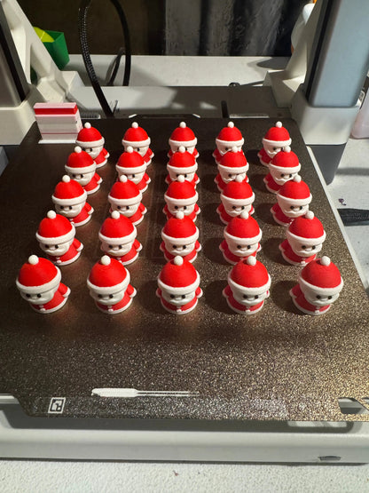 Rows of Santa Claus on a metallic surface