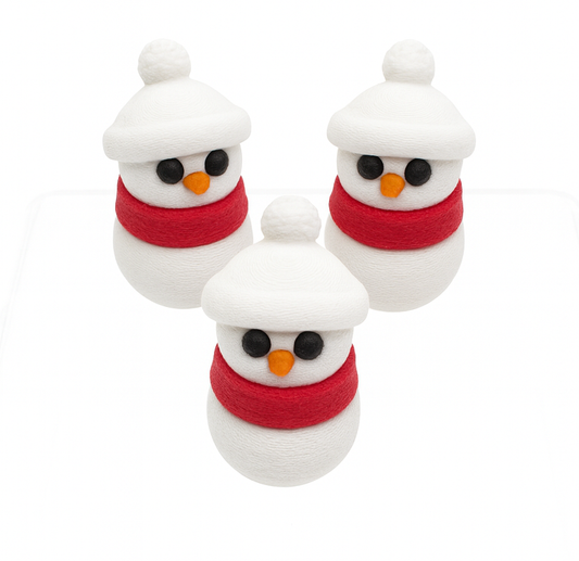 Three small snowman figurines with red scarves and carrot noses on a white background
